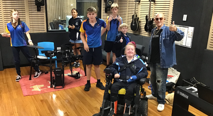 Students with disabilities including one in wheelchair taking part in music lessons
